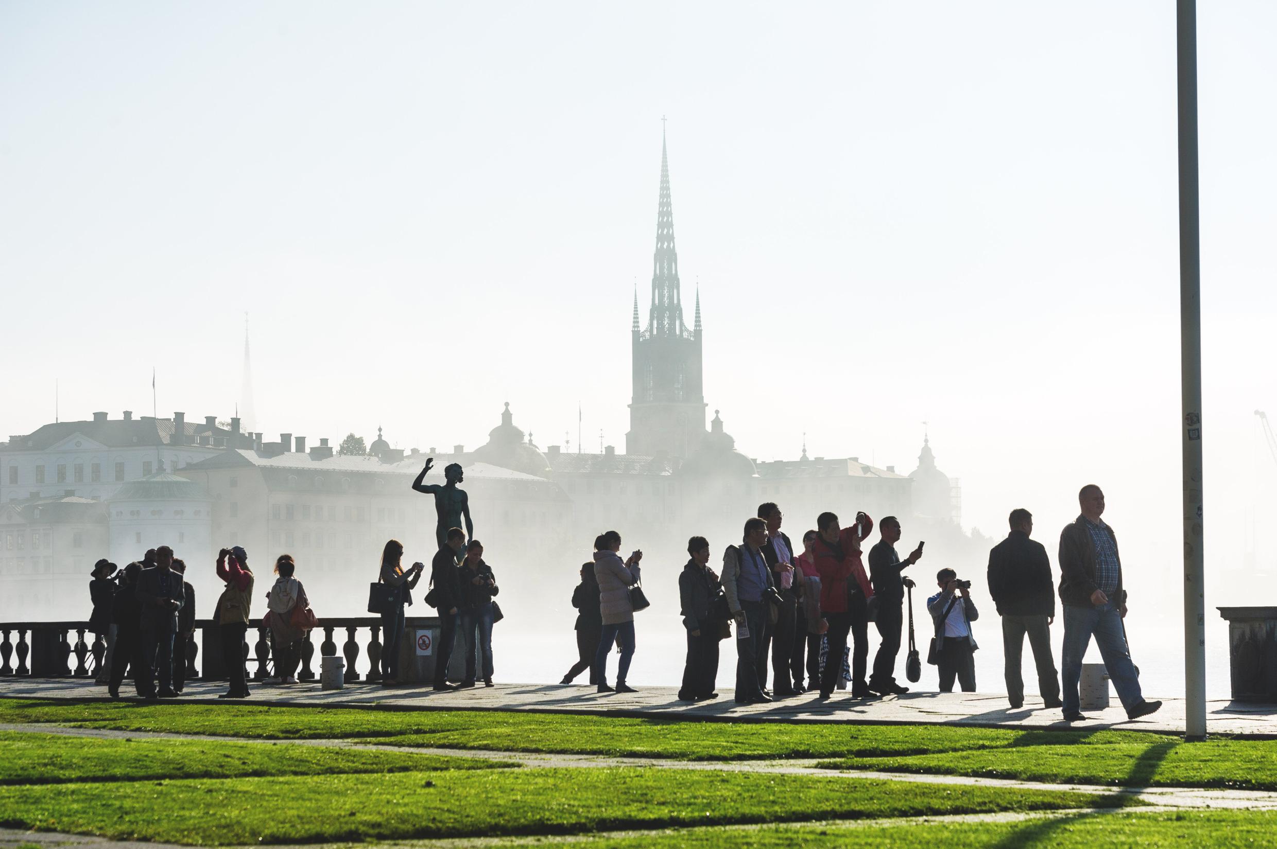 Visitors in the garden of City Hall, viewing Riddarholmen