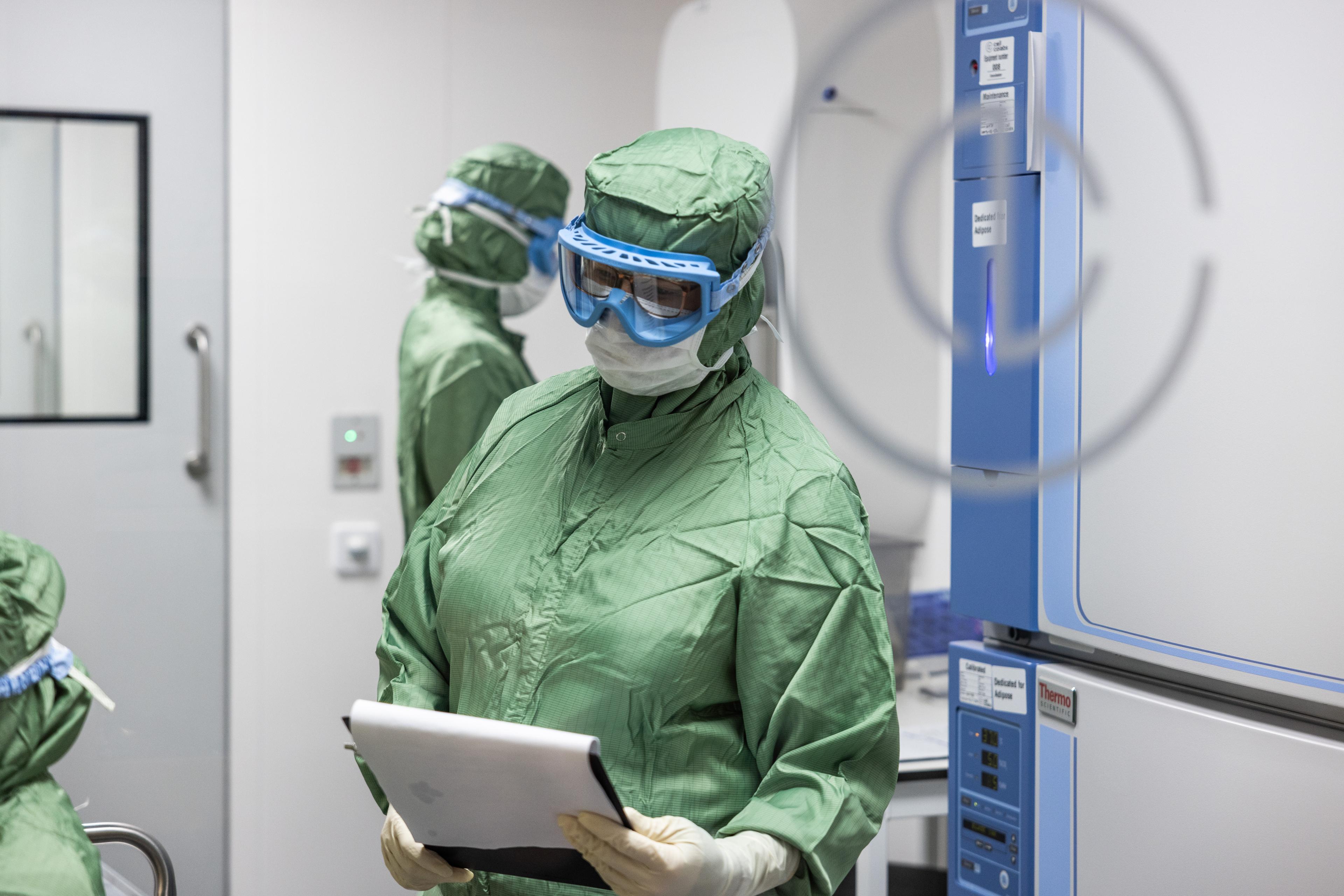 A researcher wearing protective gear.