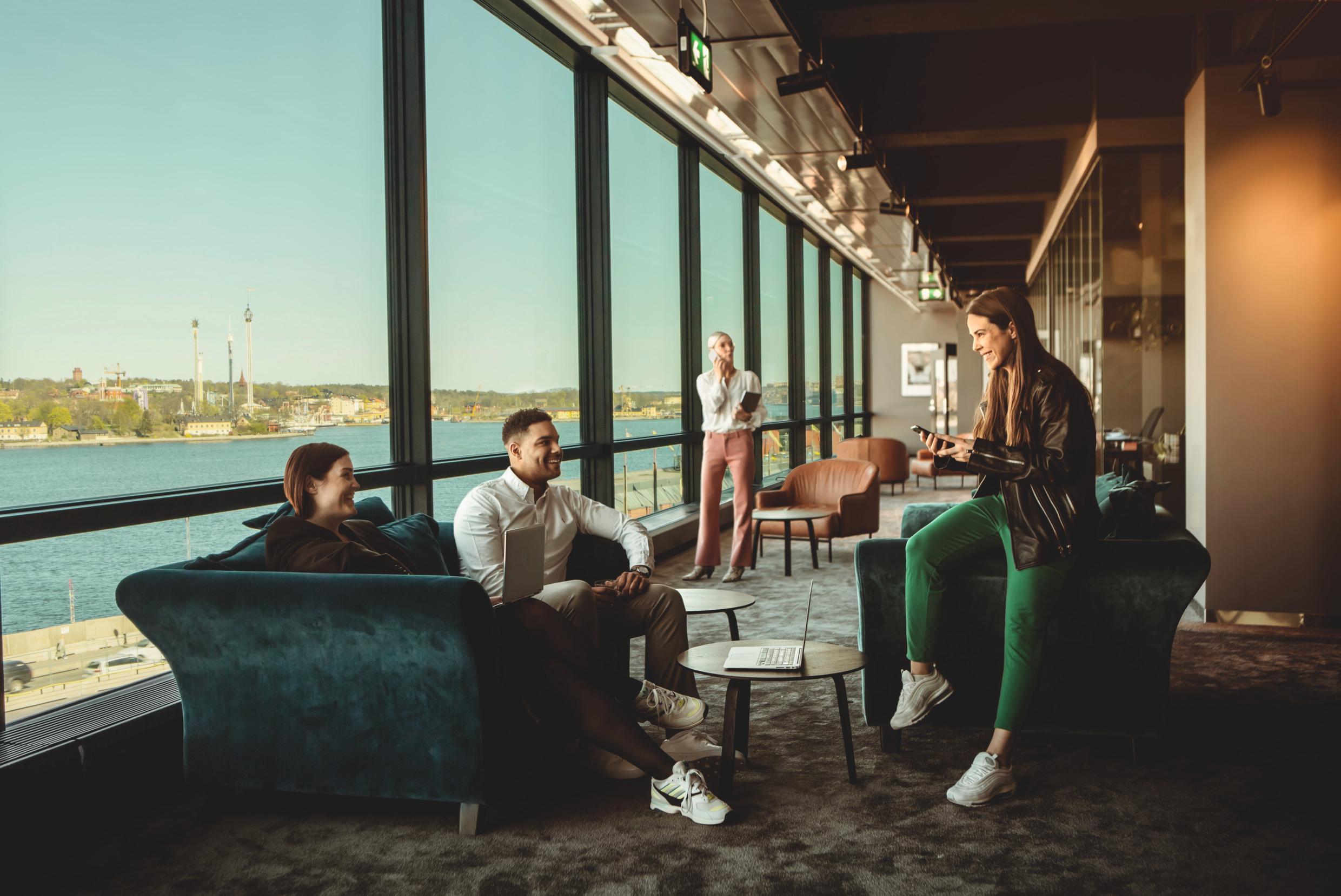 People at a coworking space in Stockholm with panoramic view over the city