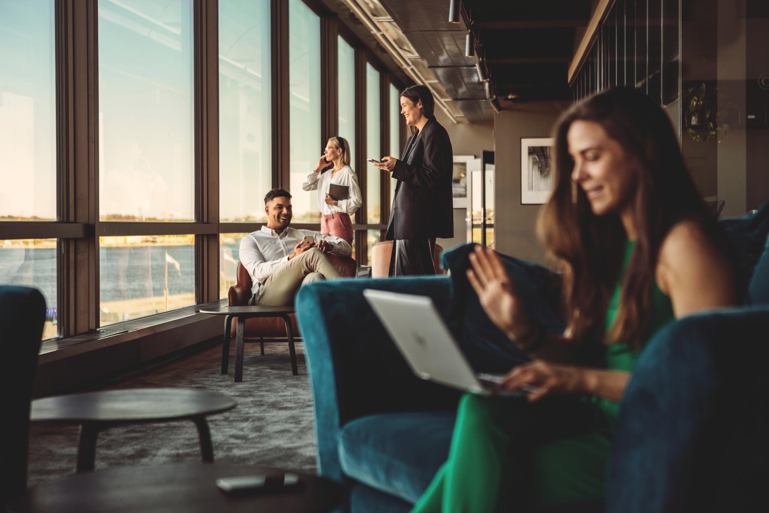 Modern lounge in Stockholm with young entrepreneurs collaborating and networking, highlighting investment opportunities in Stockholm startups.