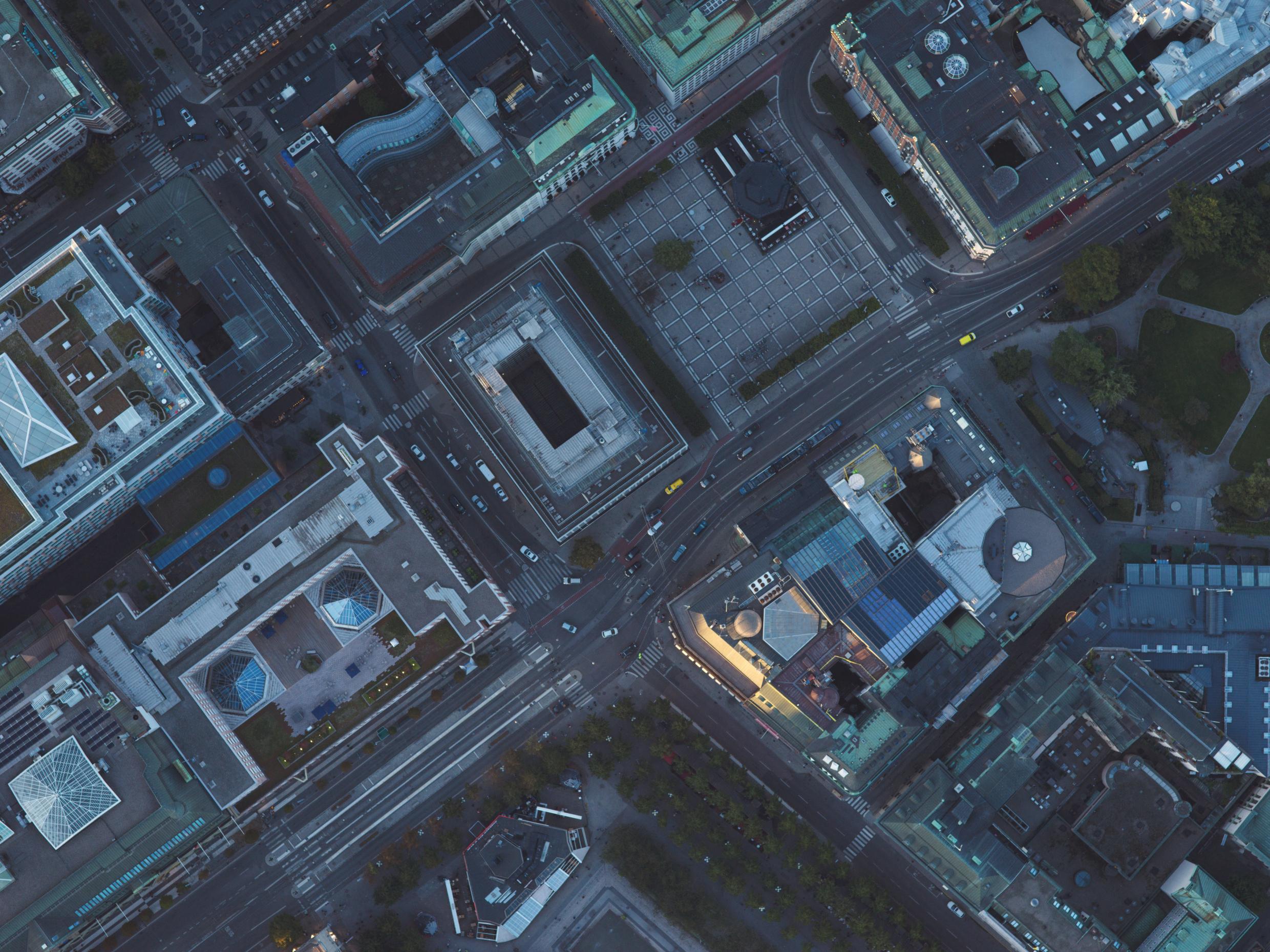 Overhead view of central Stockholm at dusk, highlighting urban planning, modern architecture, and key business locations.