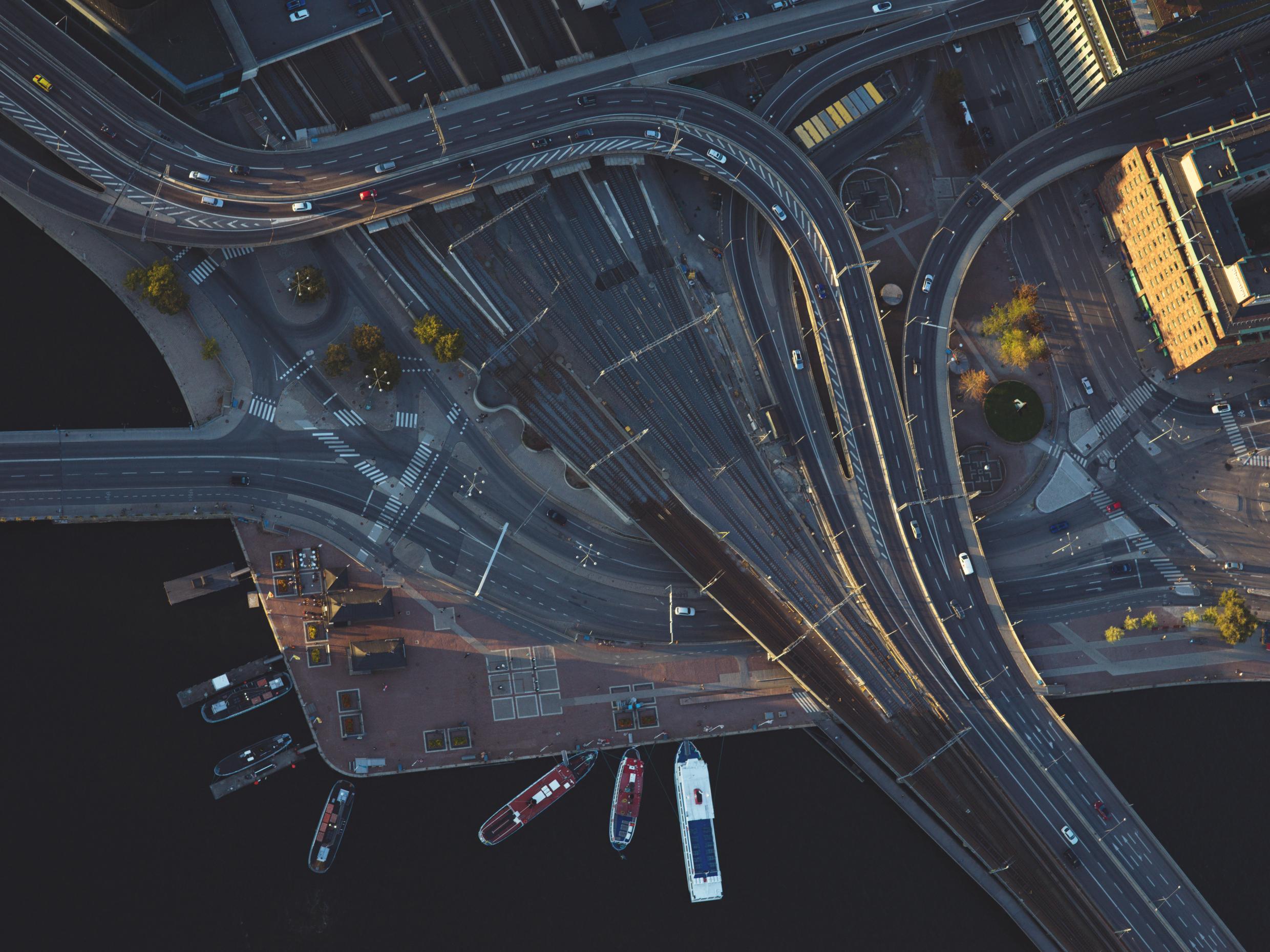 A top-down aerial view of Stockholm’s intricate road and bridge network, showcasing urban design and connectivity by the waterfront.