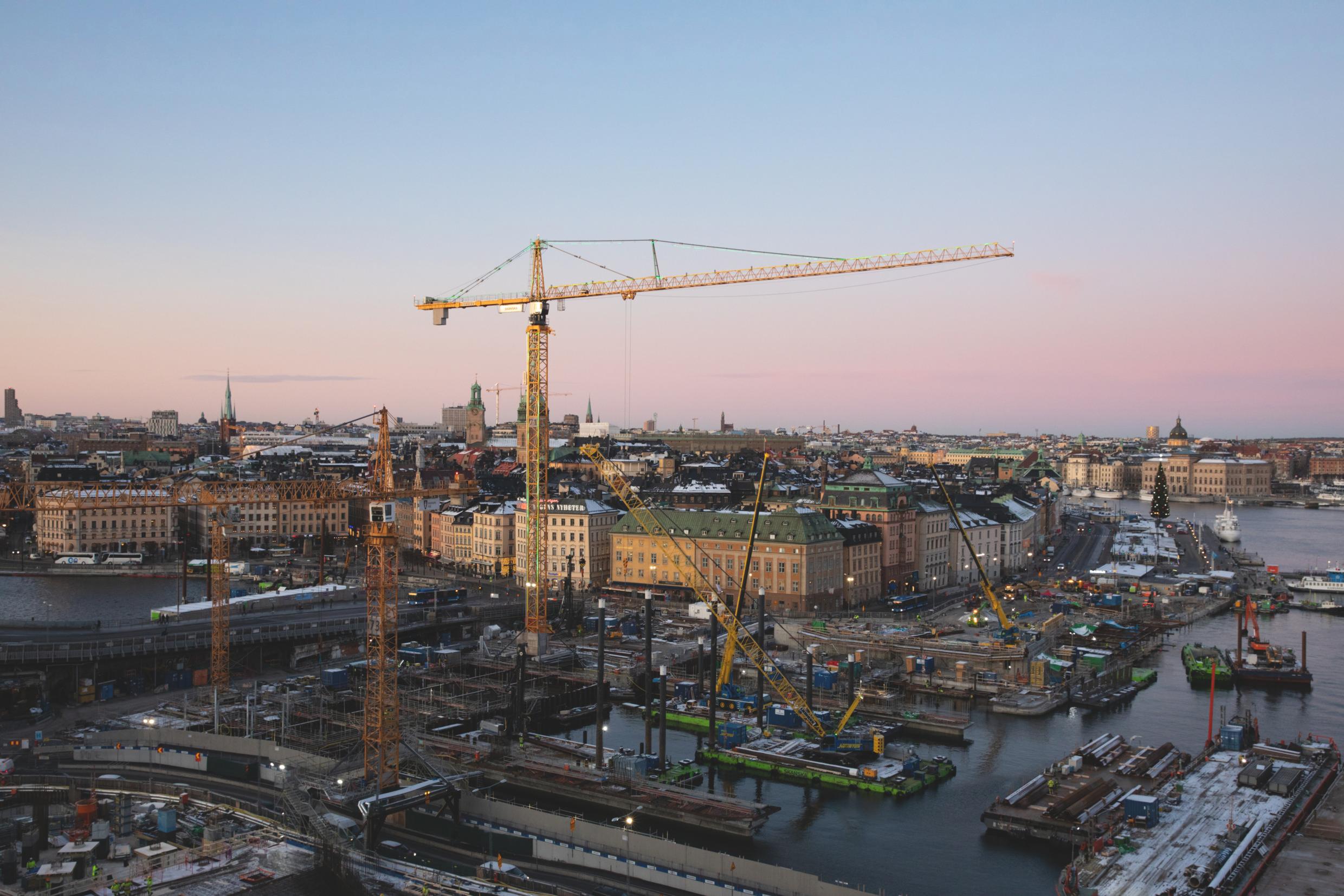 Construction cranes and ongoing development projects in Slussen at Stockholm’s city center, highlighting the transformation and modernization of the urban landscape.