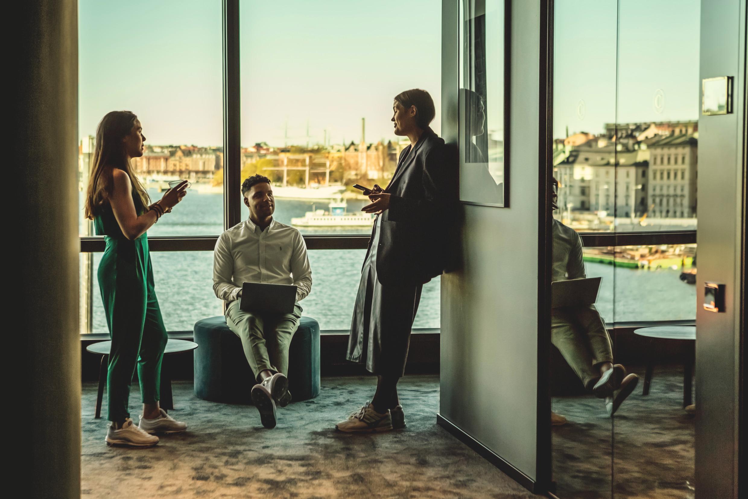 People at a coworking space in Stockholm with panoramic view over the city